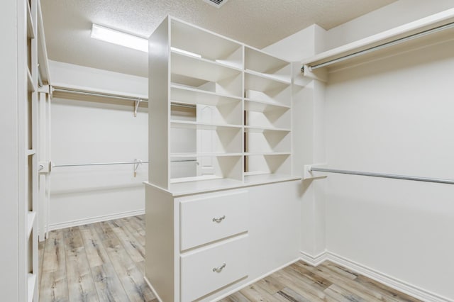 walk in closet featuring light wood-type flooring