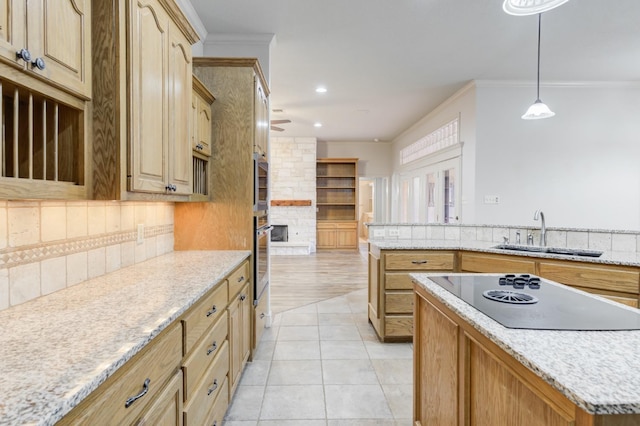 kitchen with sink, backsplash, ornamental molding, black electric cooktop, and stainless steel oven