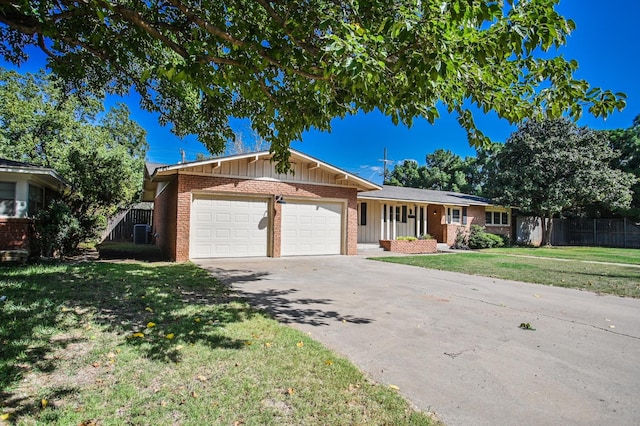 single story home with a garage and a front lawn