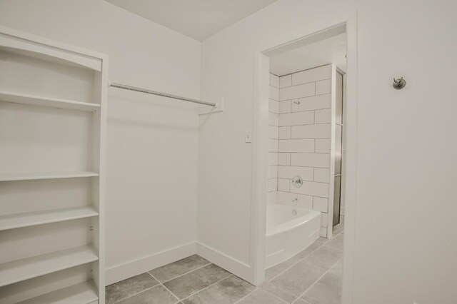 spacious closet with light tile patterned floors