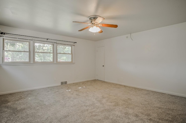 unfurnished room with carpet and ceiling fan