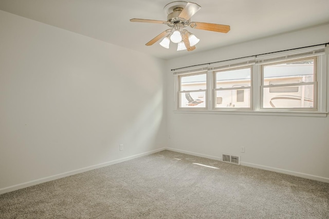 empty room with ceiling fan and carpet flooring