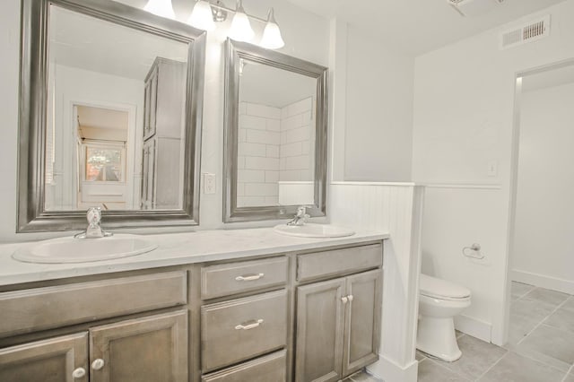 bathroom with vanity, tile patterned floors, and toilet