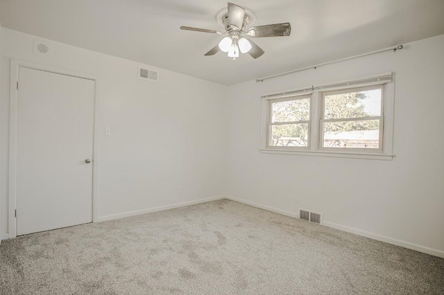 spare room featuring ceiling fan and carpet flooring