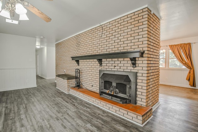 unfurnished living room featuring wood-type flooring and ceiling fan