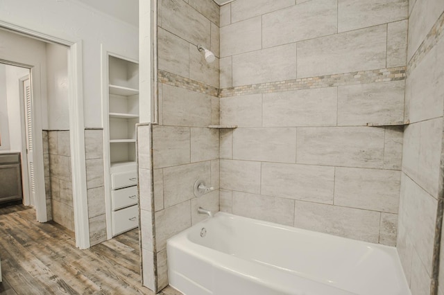 bathroom featuring hardwood / wood-style flooring and tiled shower / bath combo