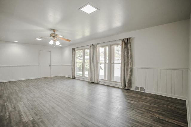 empty room featuring dark hardwood / wood-style flooring and ceiling fan