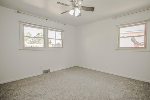 spare room featuring carpet and ceiling fan