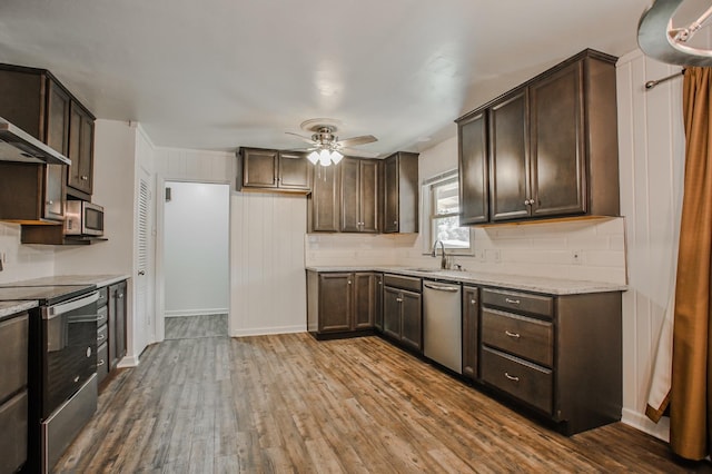 kitchen with dark brown cabinetry, hardwood / wood-style flooring, and appliances with stainless steel finishes