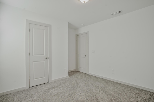unfurnished bedroom with baseboards, visible vents, and carpet flooring