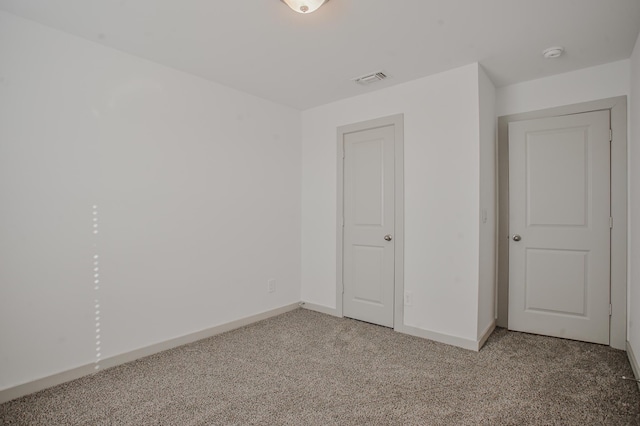 unfurnished bedroom featuring baseboards and light colored carpet