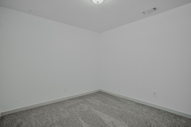 spare room featuring visible vents, carpet, and baseboards