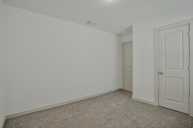 unfurnished bedroom featuring visible vents, light carpet, and baseboards