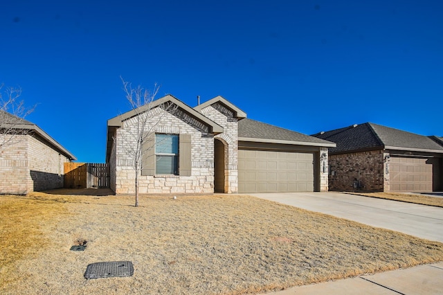 view of front of house featuring fence, concrete driveway, brick siding, and an attached garage