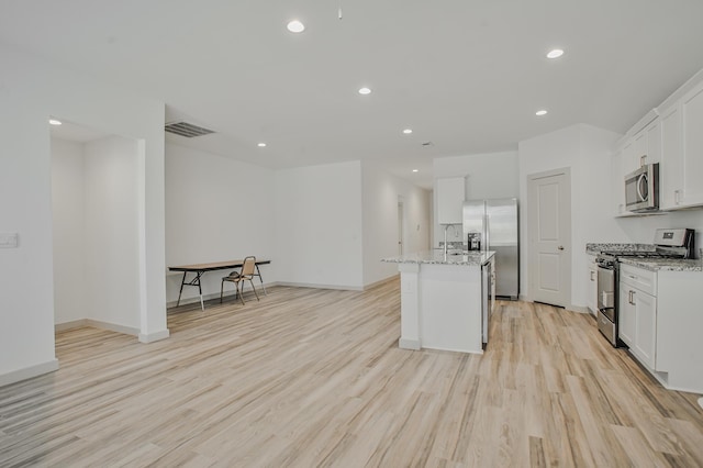kitchen featuring recessed lighting, appliances with stainless steel finishes, light wood finished floors, a sink, and visible vents