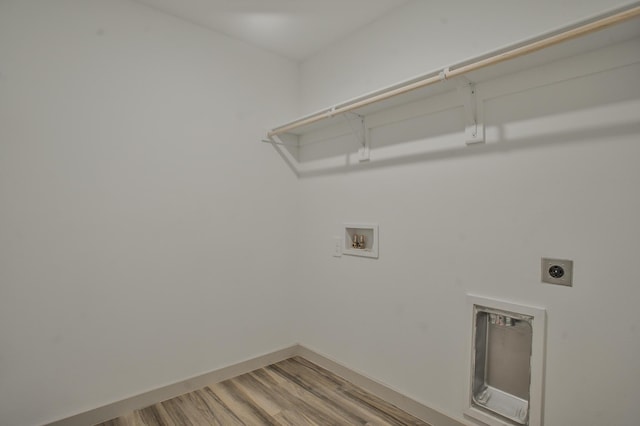 laundry room featuring laundry area, hookup for an electric dryer, washer hookup, light wood finished floors, and baseboards