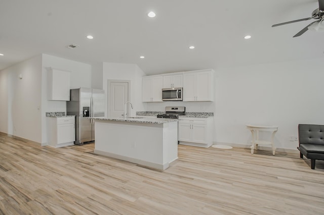 kitchen featuring a sink, stainless steel appliances, a ceiling fan, light wood-style flooring, and white cabinets