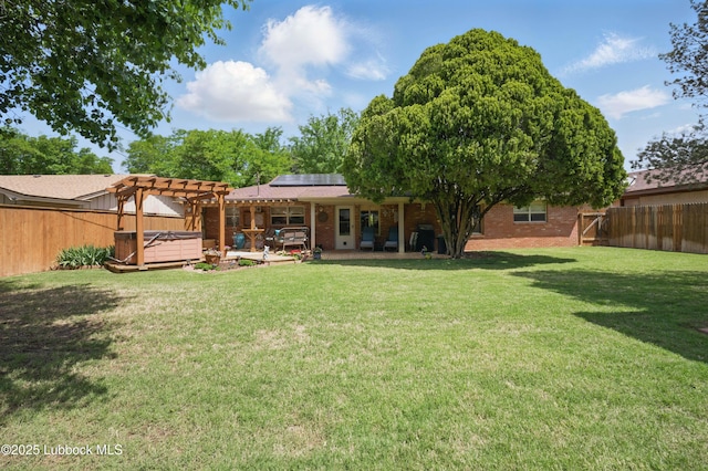 4405 56th St, Lubbock, TX 79414 - back of house with a hot tub, a pergola, solar panels, brick siding, and a patio area