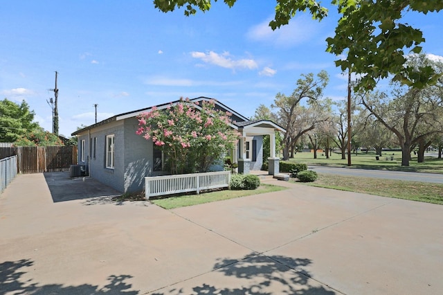 view of front facade featuring a patio and central AC