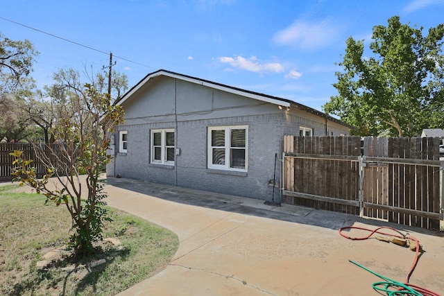 view of side of property with a patio