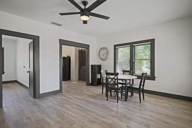 dining room with ceiling fan and light hardwood / wood-style floors