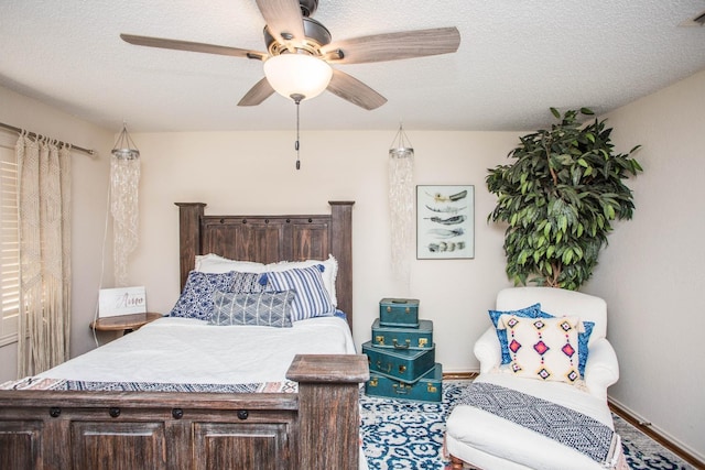 bedroom with ceiling fan and a textured ceiling