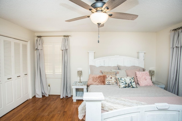 bedroom with ceiling fan, a closet, dark hardwood / wood-style floors, and a textured ceiling