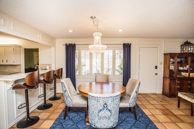 dining space featuring light tile patterned floors and a chandelier