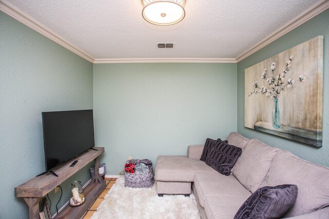 living room featuring ornamental molding and a textured ceiling