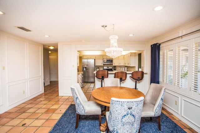 tiled dining area with a notable chandelier