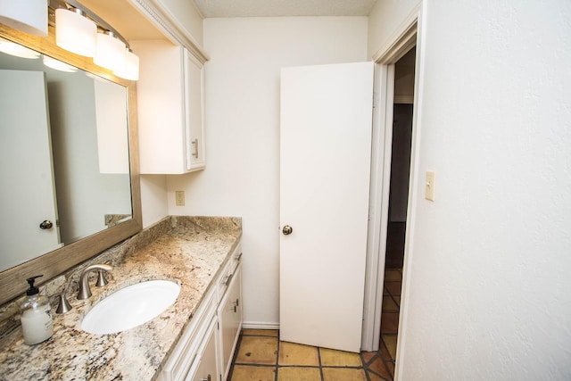 bathroom with tile patterned floors and vanity