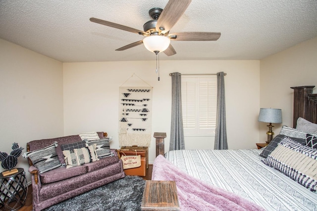 bedroom featuring ceiling fan and a textured ceiling