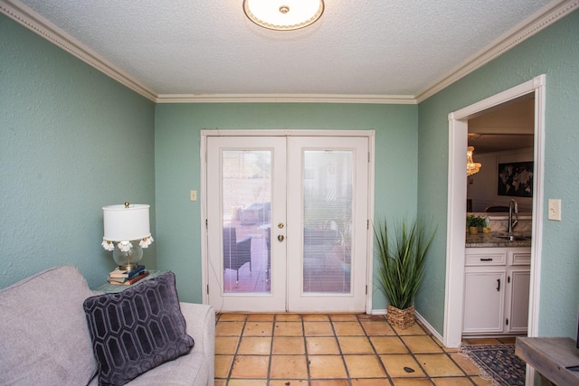 entryway with crown molding, sink, a textured ceiling, and french doors