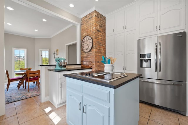 kitchen with a kitchen island, stainless steel refrigerator with ice dispenser, dark countertops, black electric cooktop, and light tile patterned floors