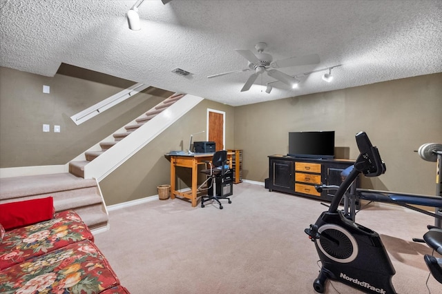 workout area featuring visible vents, carpet flooring, a textured ceiling, and ceiling fan