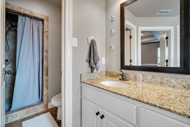 bathroom featuring vanity, toilet, and walk in shower