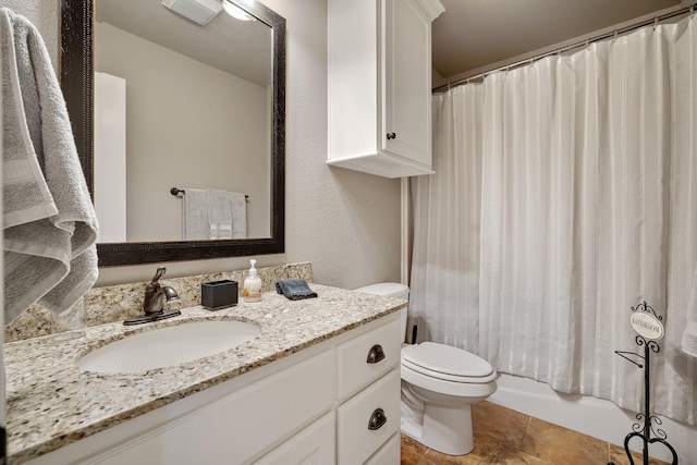 full bathroom featuring vanity, shower / bathtub combination with curtain, and toilet