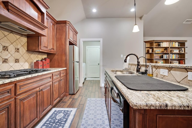 kitchen featuring lofted ceiling, sink, pendant lighting, stainless steel appliances, and custom exhaust hood