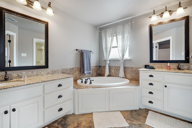 bathroom with vanity and a bath