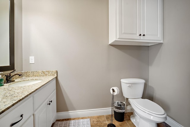 bathroom featuring vanity, tile patterned floors, and toilet