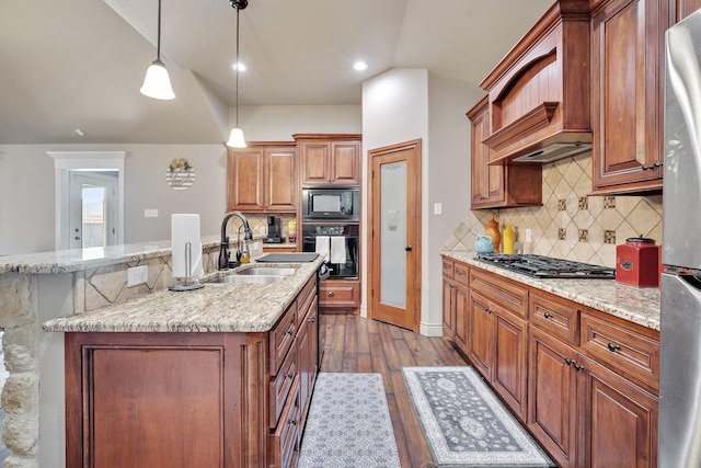 kitchen with sink, black appliances, custom range hood, decorative light fixtures, and vaulted ceiling