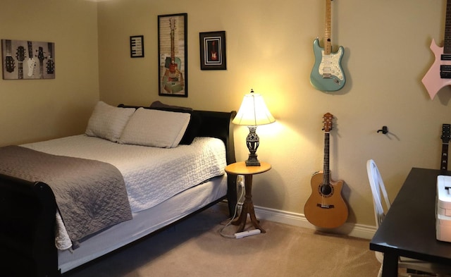 carpeted bedroom featuring baseboards