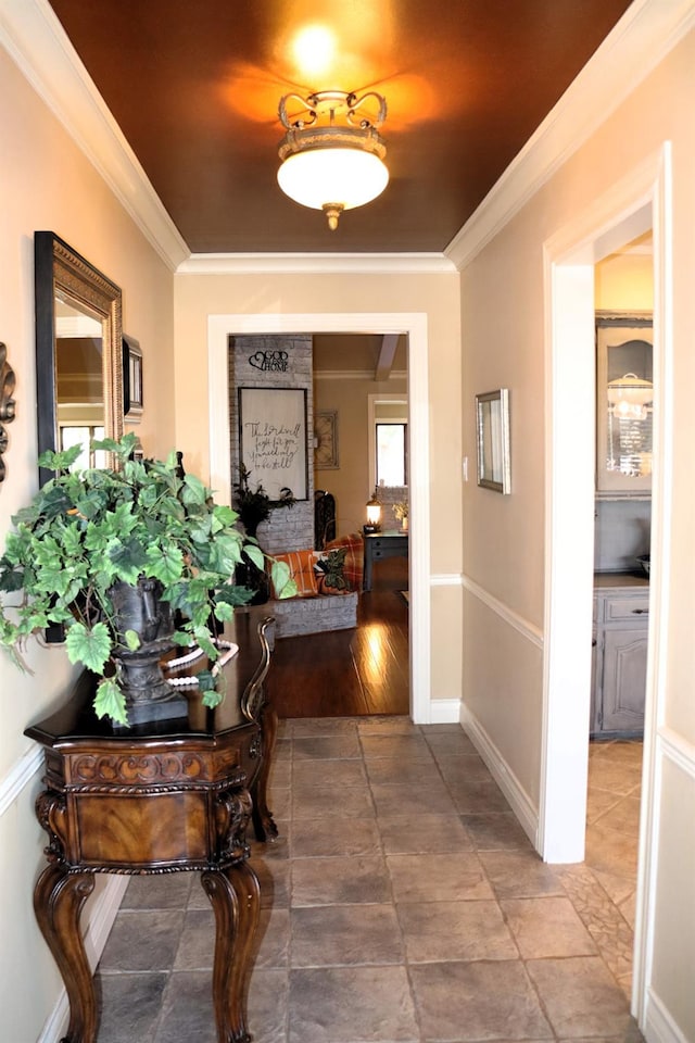 hallway with baseboards and crown molding