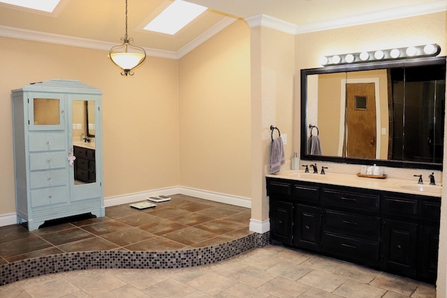 bathroom with a skylight, a sink, and crown molding