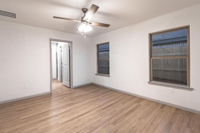 unfurnished room featuring light hardwood / wood-style floors and ceiling fan