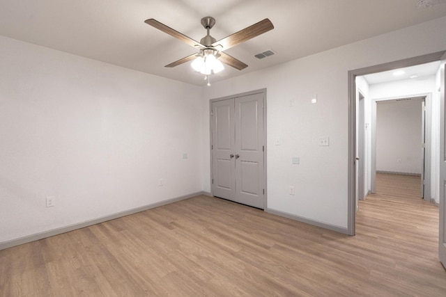 unfurnished bedroom with ceiling fan and light wood-type flooring