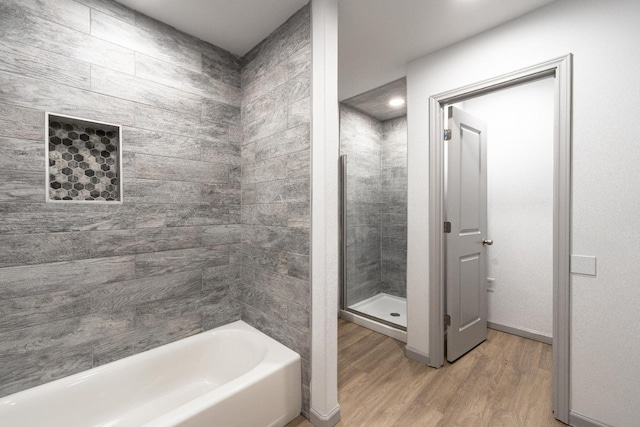 bathroom with wood-type flooring and separate shower and tub