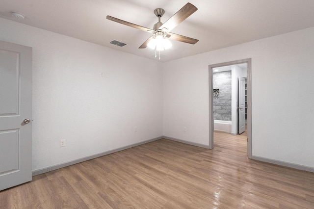 spare room featuring ceiling fan and light wood-type flooring