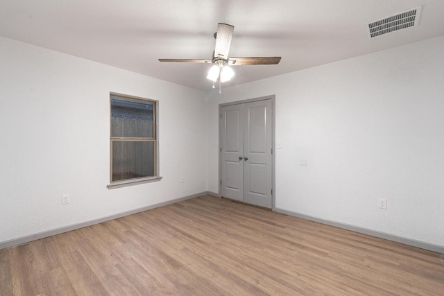 empty room featuring ceiling fan and light hardwood / wood-style flooring