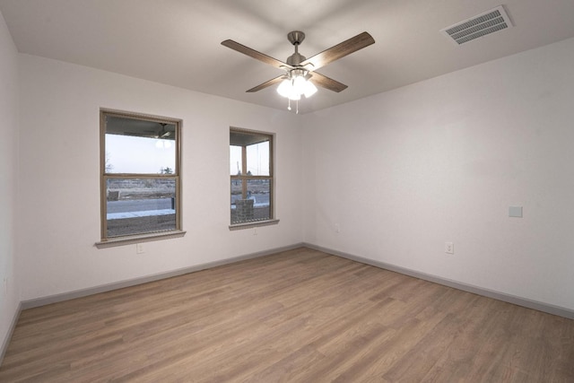 spare room with ceiling fan and light hardwood / wood-style flooring